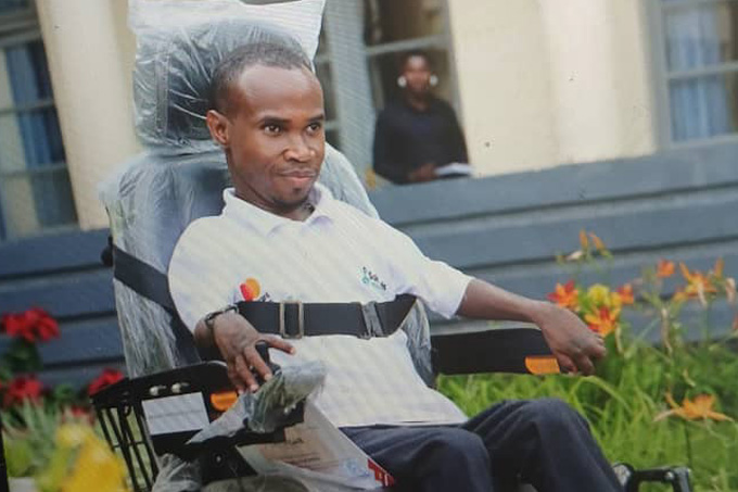 Godfrey Rukimbira, a Mastercard Foundation Scholar at the University of Rwanda after receiving a new electronic wheelchair